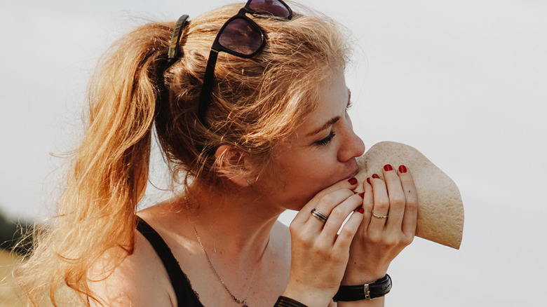 girl eating taco