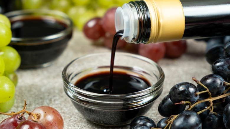 Balsamic vinegar being poured into a small glass bowl