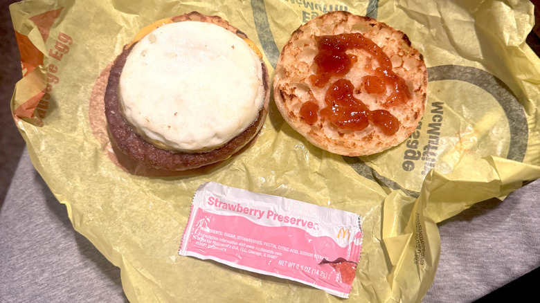 Sausage McMuffin with egg, open faced, with strawberry preserves