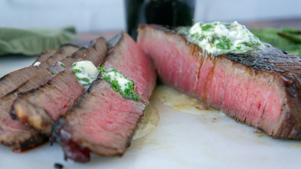 sliced steak with herb butter