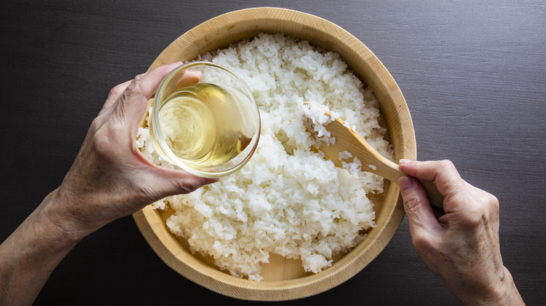 Person stirring sushi rice