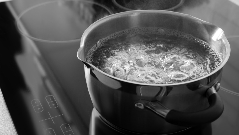 A pot of boiling water on a stove