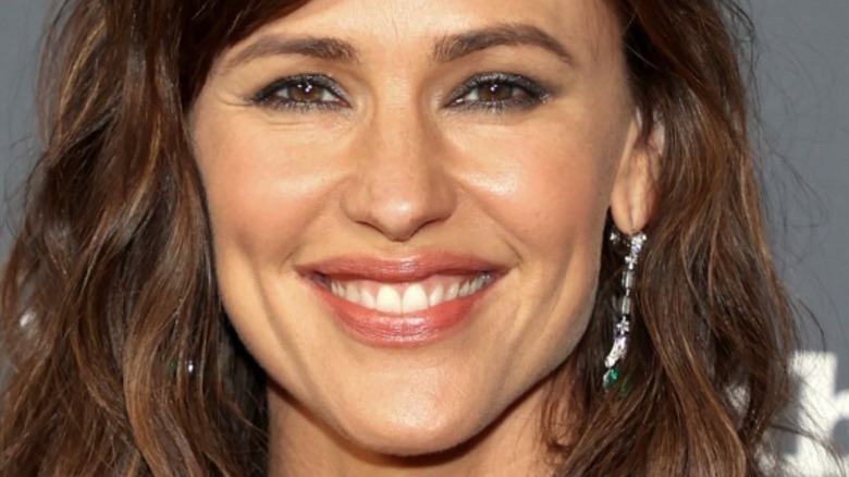 Jennifer Garner smiling and wearing earrings