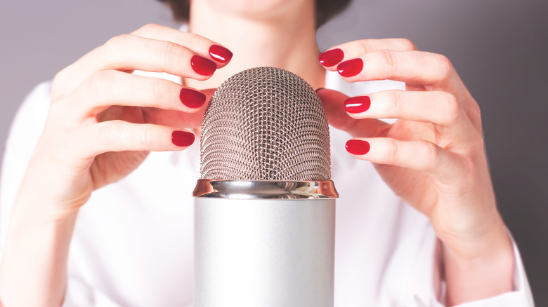 Woman touching microphone