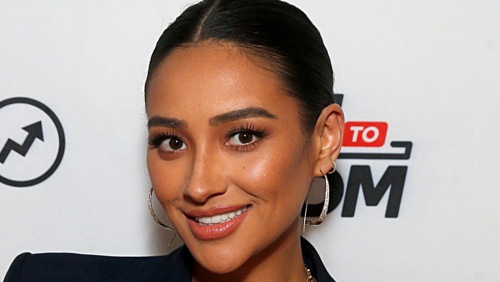 Shay Mitchell wearing gold hoops