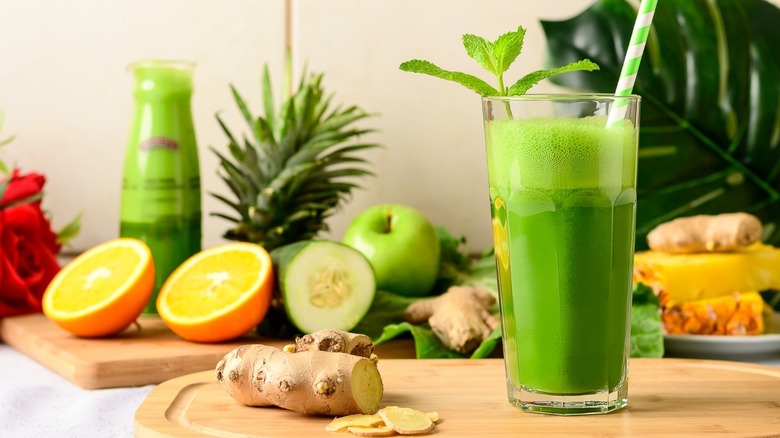 aloe vera juice with fruit in background