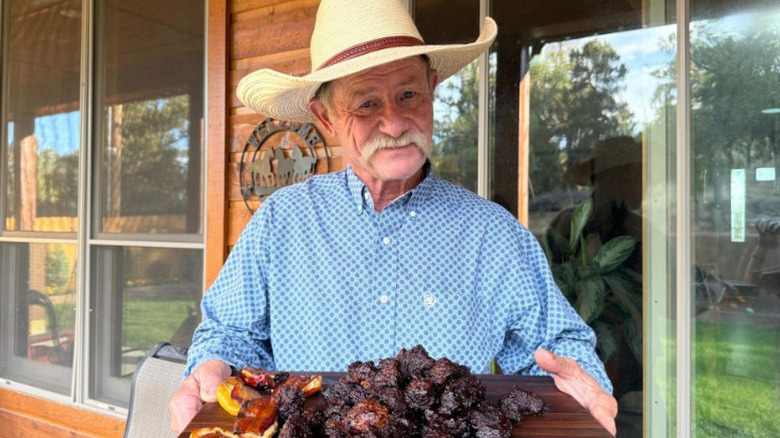 Kent Rollins smiling with food