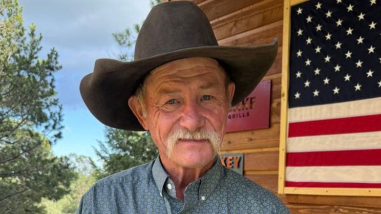 Kent Rollins wearing hat smiling