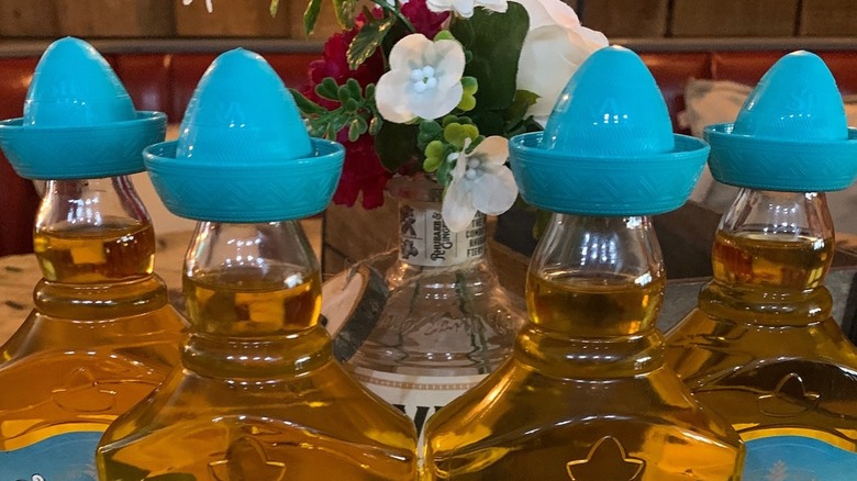tequilla bottles with blue hats 