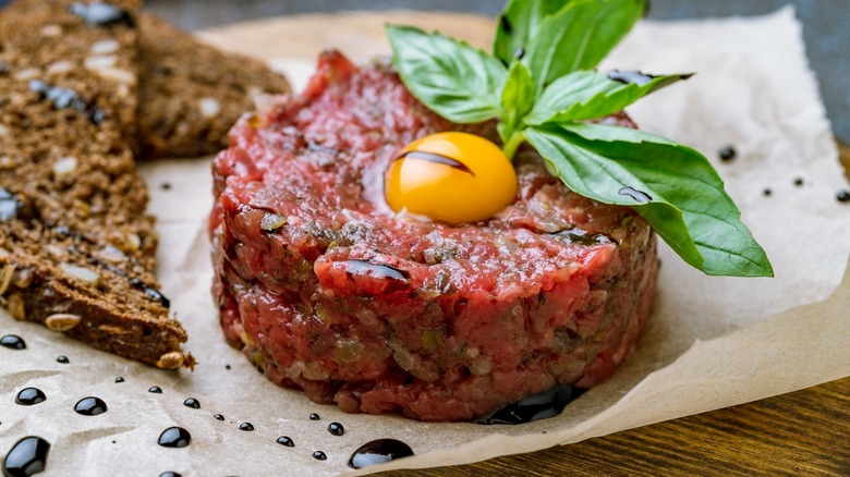 beef tartare with egg yolk and garnish