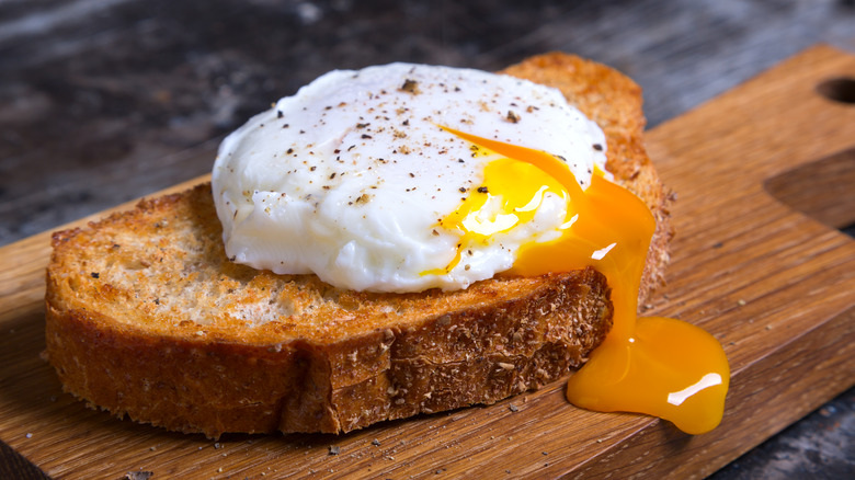 Runny poached egg on toast