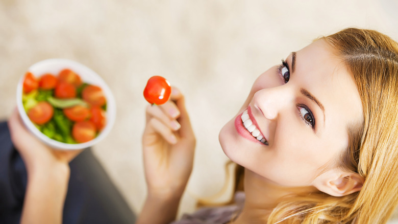 woman eating cherry tomatoes