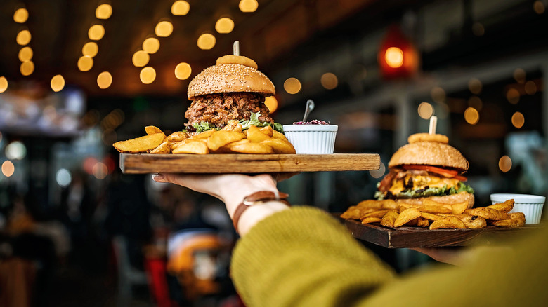 server carrying burgers