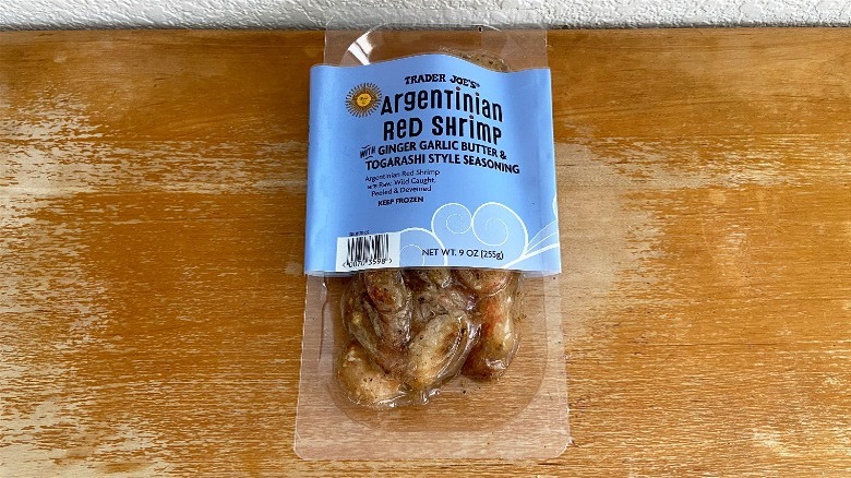 Package of Trader Joe's Argentinian red shrimp on wooden table.