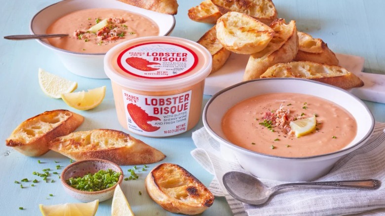 Trader Joe's lobster bisque soup in container, bowls, and with bread