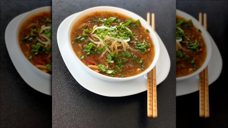 Chinese soup in bowl with chopsticks