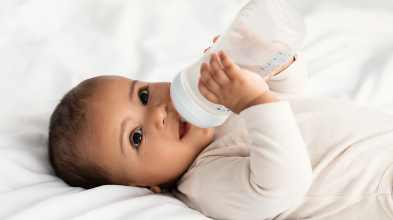 A baby with a bottle