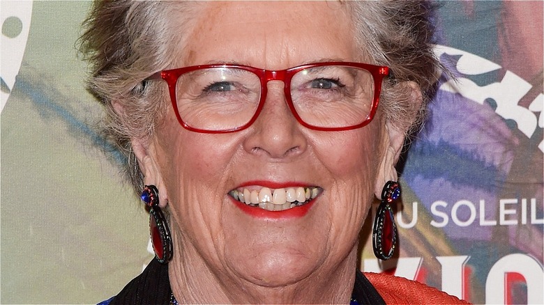 prue leith smiles with red lipstick and red glasses