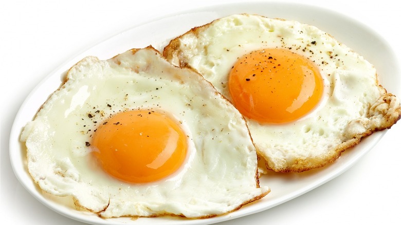 Two sunny-side-up fried eggs