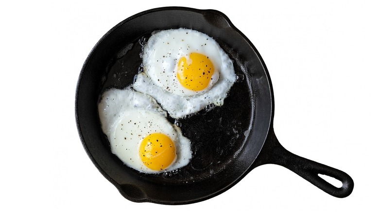 Fried eggs cooking in pan