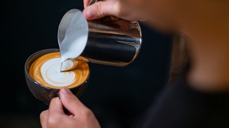 Frothy milk poured into coffee