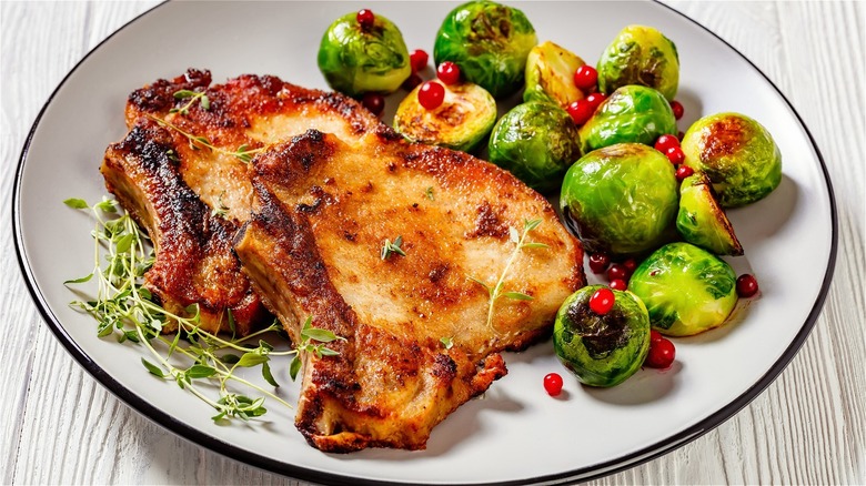 pork chops and Brussels sprouts on white plate