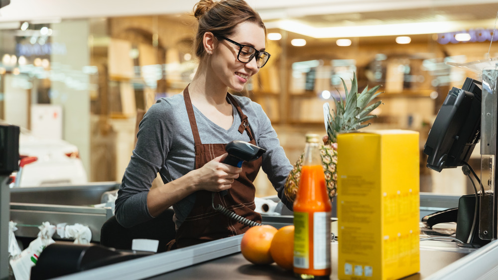 cashier scanning items at grocery store