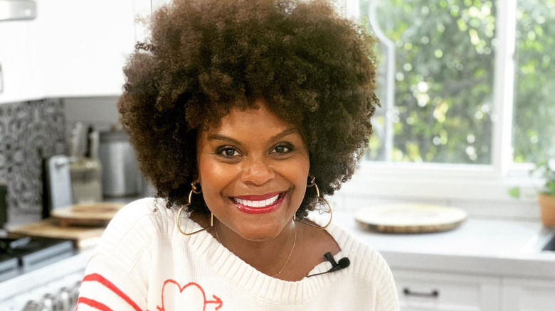 Tabitha Brown smiling in the kitchen