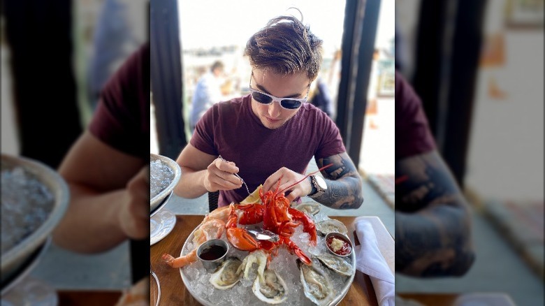 Alex Lenik eating seafood