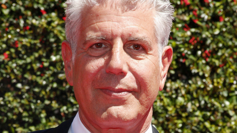 Anthony Bourdain against green backdrop