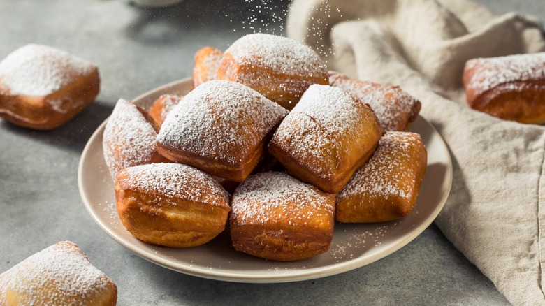 plate of New Orleans style beignets with powdered sugar