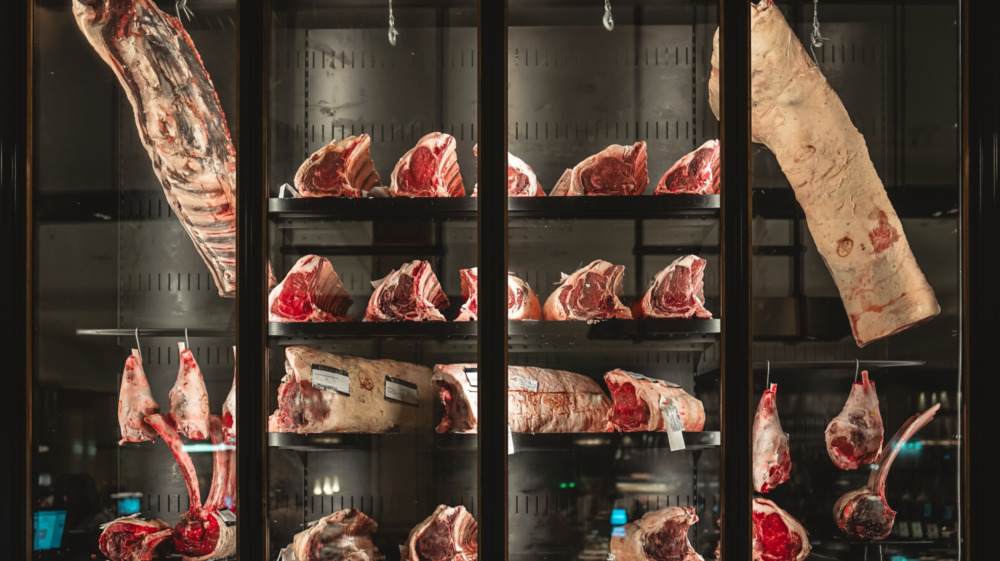 cuts of meat hanging and drying in a butcher shop