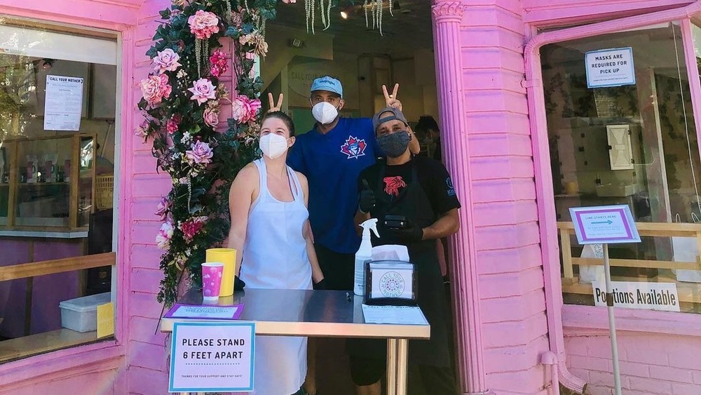 Deli exterior with owners 