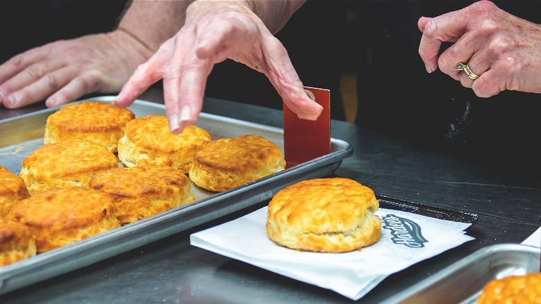 Person judging tray of Hardee's biscuits