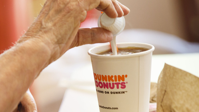Cream in cup of Dunkin' coffee 