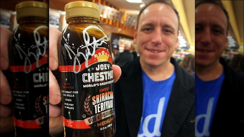 Joey Chestnut holding srirachi teriyaki sauce