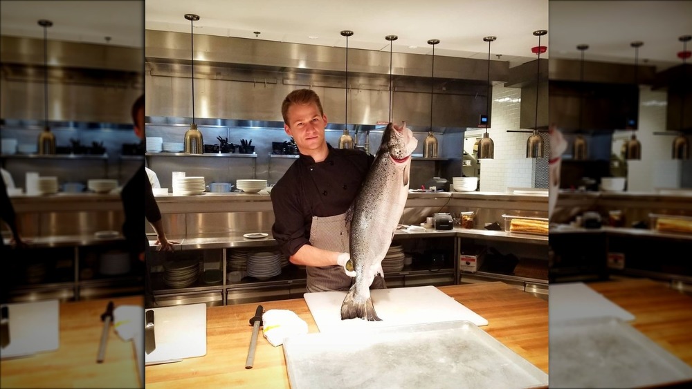 Chef Josh Oakley holding up a fish