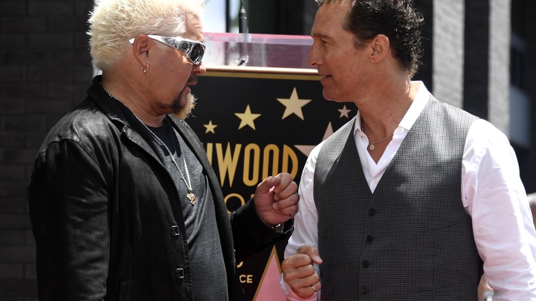 Guy Fieri and Matthew McConaughey fist bumping