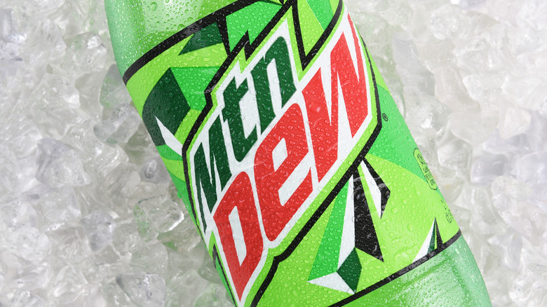 A green bottle of Mountain Dew on ice