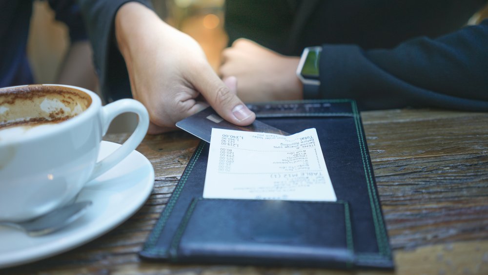 A customer pays his bill at a restaurant