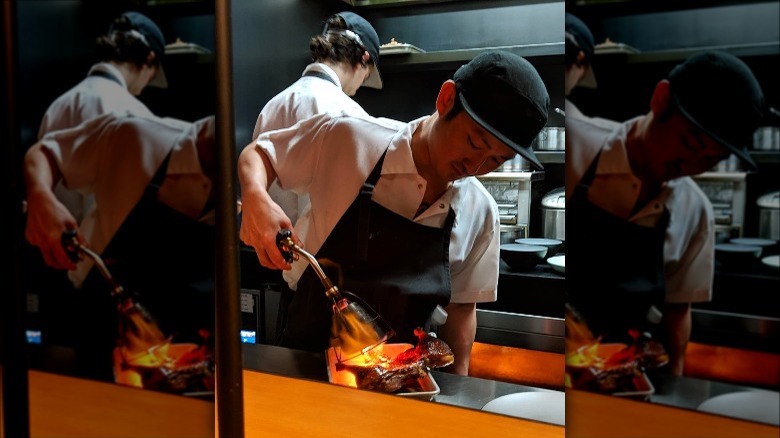 Chef Sam Kang using blow torch