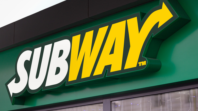 Green, yellow, and white Subway restaurant sign