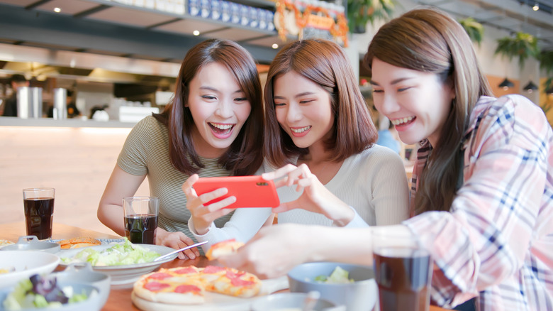 Foodies taking restaurant photos