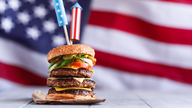 Fireworks-topped triple burger with American flag