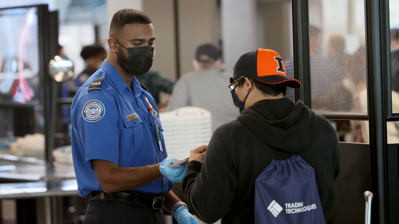 TSA employee checking in an airline passenger