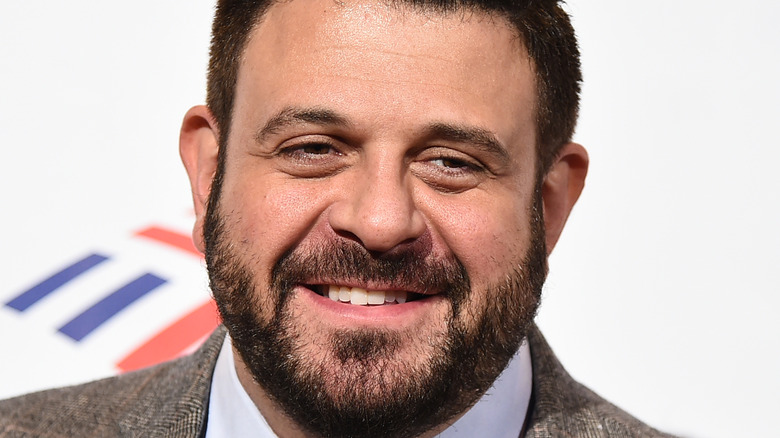 Closeup of Adam Richman in a suit with beard