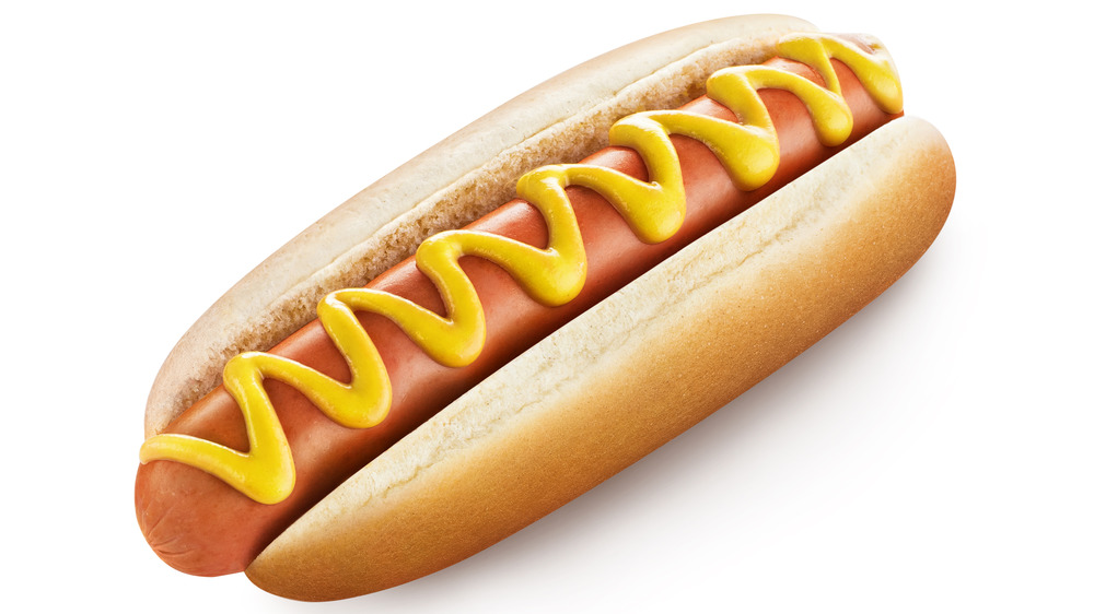 Hot dog on bun with mustard
