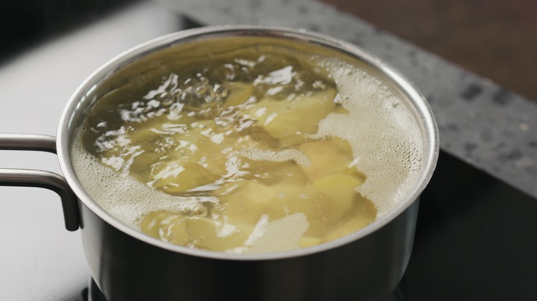 Potatoes boiling in saucepan