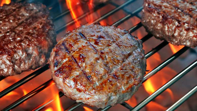 Burger patties cooking on a grill