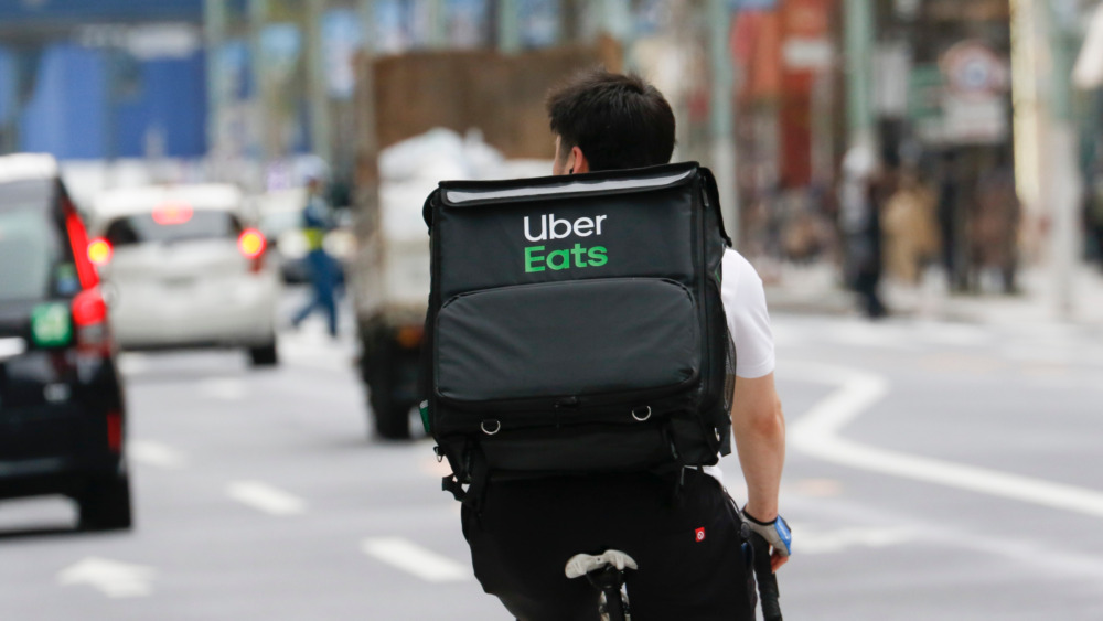 Person on a bicycle with an Uber Eats bag